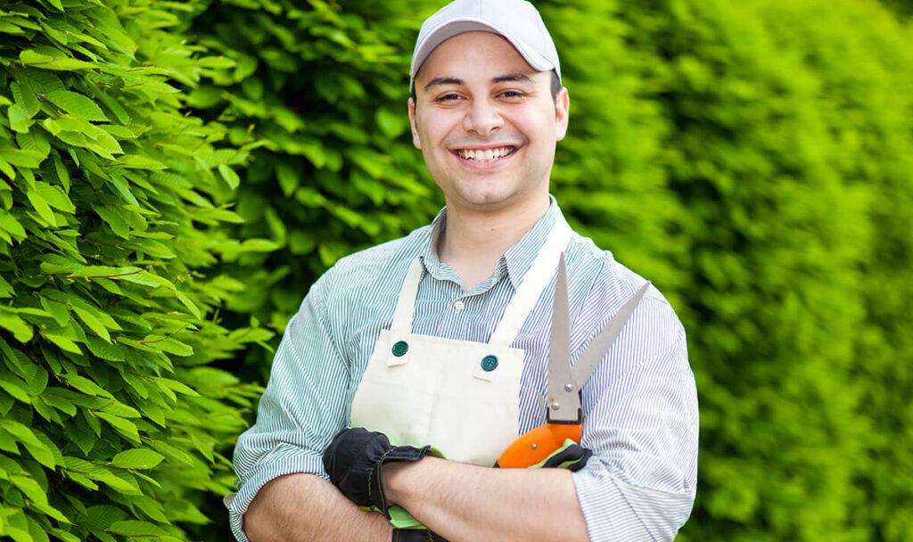 Xterior Xpectations - the process gardner smiling with garden sheers